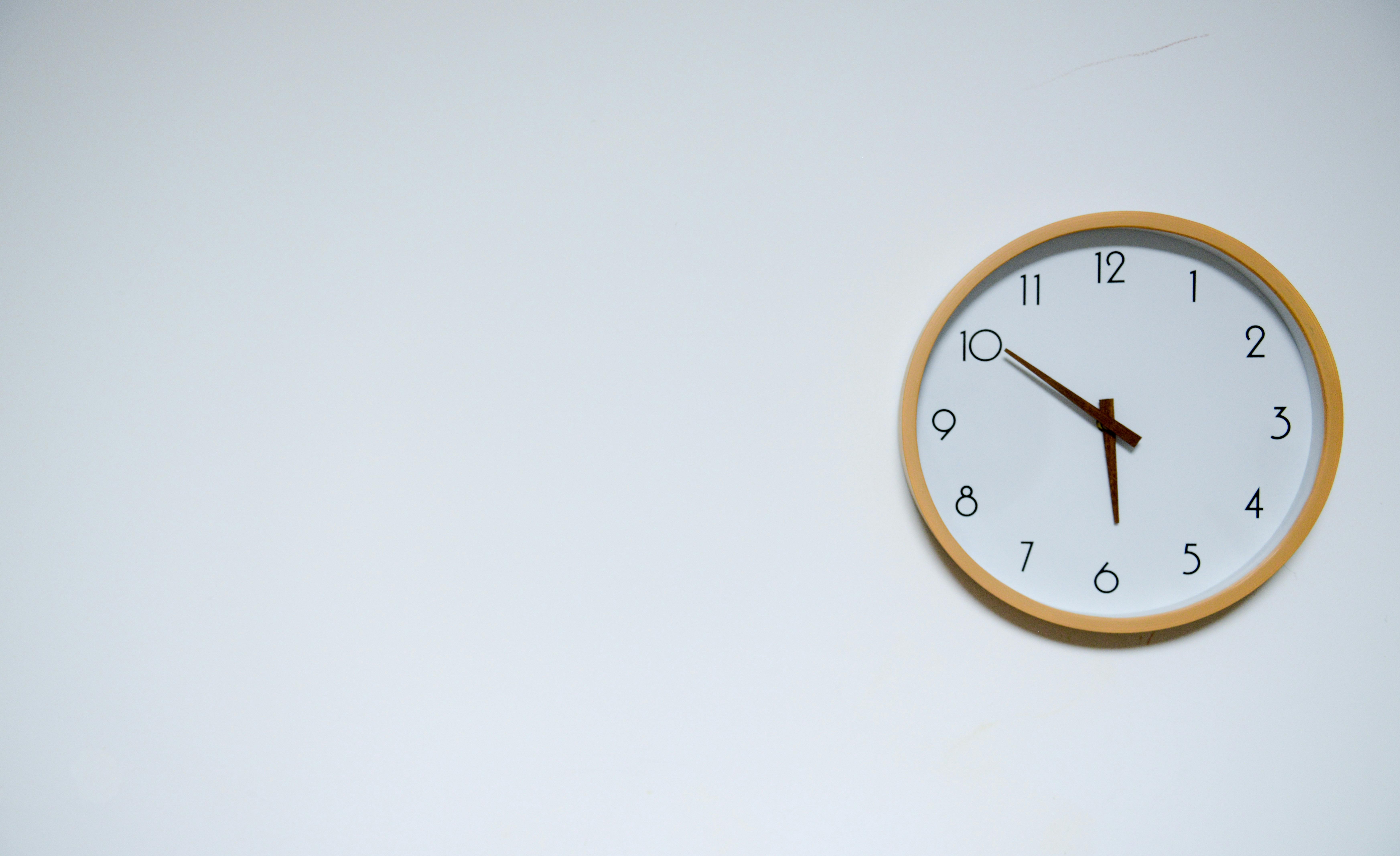 black coffee for weight loss, clock off to the right with white wall background